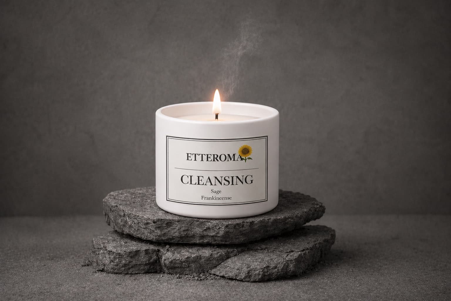 Two Etteroma candles lit on a travertine ledge beside a stone vase and books